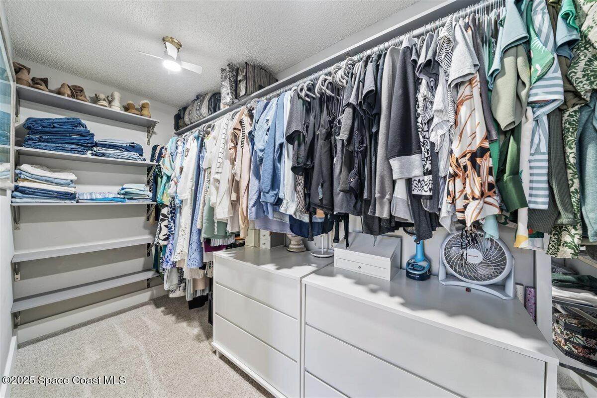 470 Rio Vista Lane Merritt Island, FL 32952 - Photo 24 of 54 a view of walk in closet with clothes and shoes