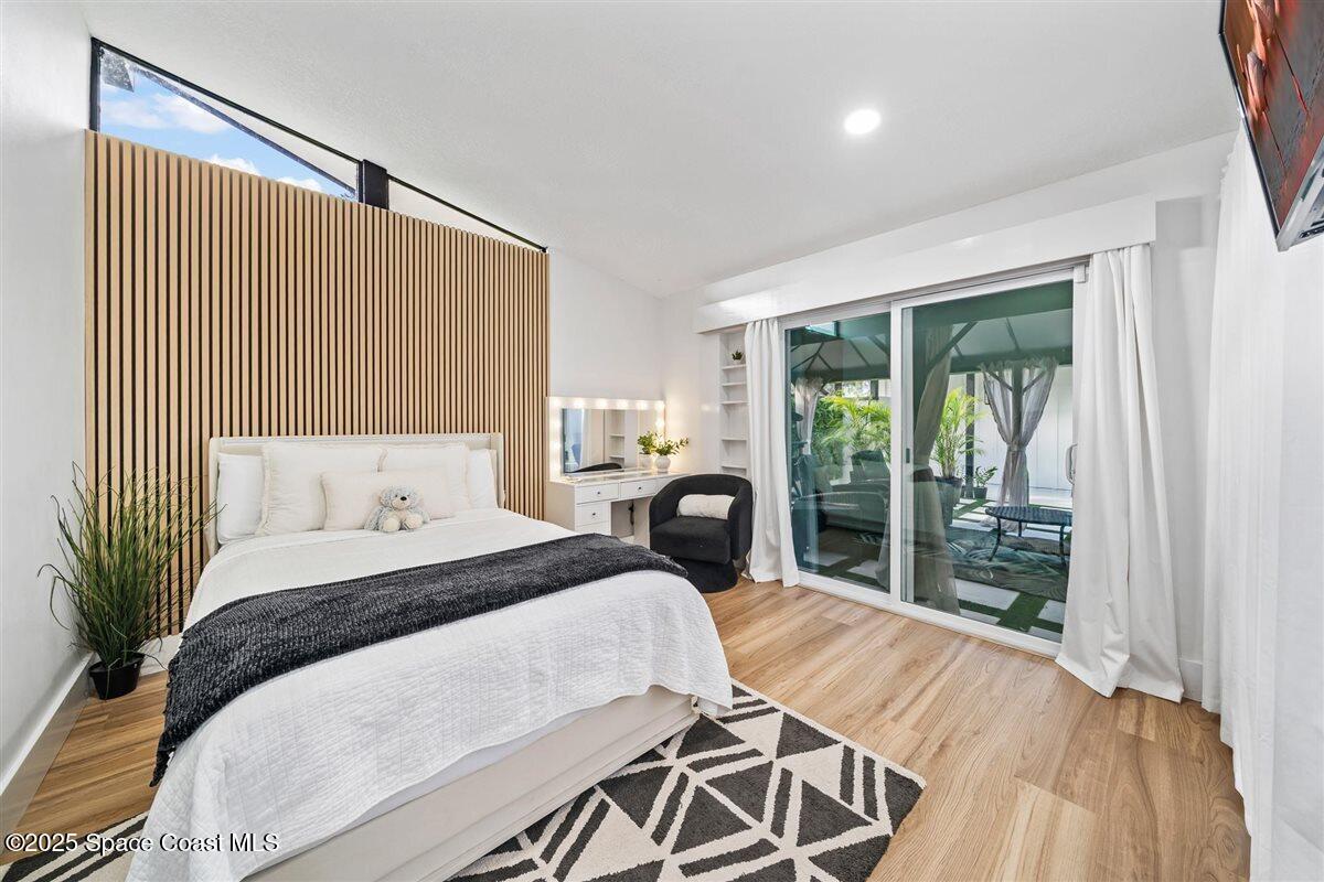 470 Rio Vista Lane Merritt Island, FL 32952 - Photo 27 of 54 a bed sitting in a bedroom next to a window