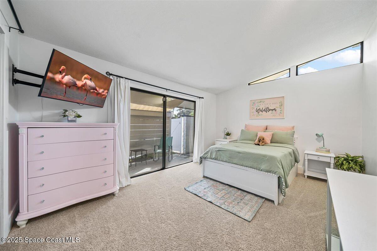 470 Rio Vista Lane Merritt Island, FL 32952 - Photo 29 of 54 a spacious bedroom with a bed and a flat screen tv