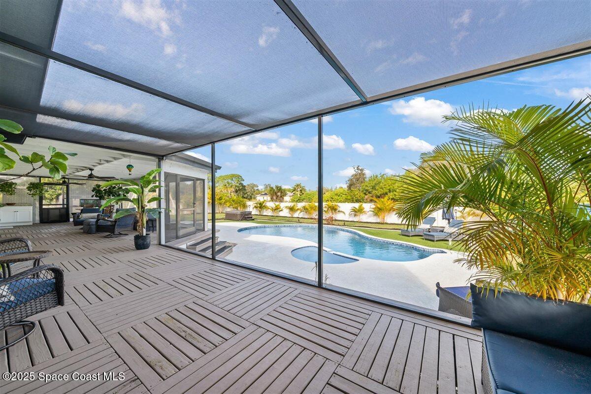 470 Rio Vista Lane Merritt Island, FL 32952 - Photo 36 of 54 a view of a patio with a table and chairs next to a yard