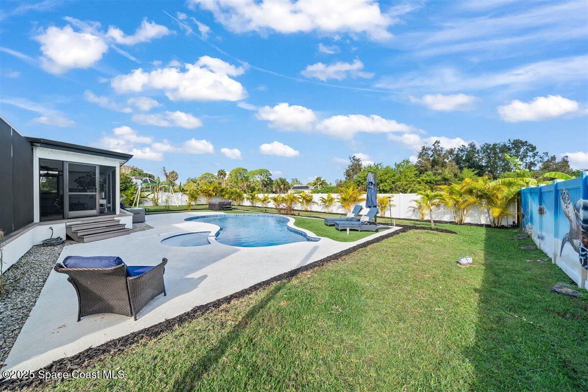 470 Rio Vista Lane Merritt Island, FL 32952 - Photo 38 of 54 a view of a house with swimming pool and sitting area