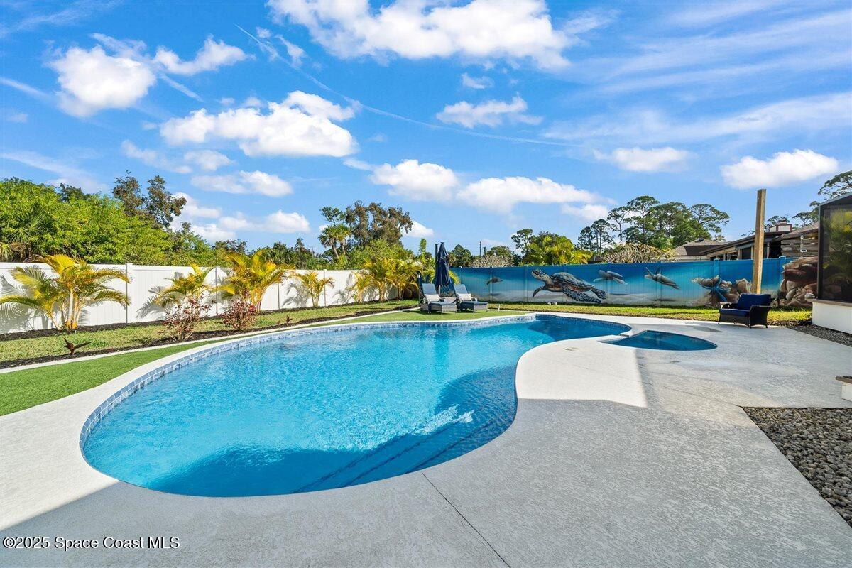 470 Rio Vista Lane Merritt Island, FL 32952 - Photo 40 of 54 a view of a swimming pool with an outdoor seating and a garden