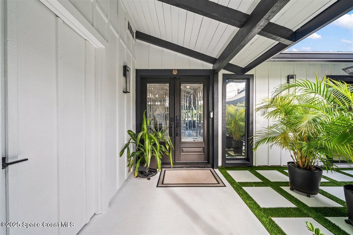 470 Rio Vista Lane Merritt Island, FL 32952 - Photo 5 of 54 a porch with seating space and potted plants