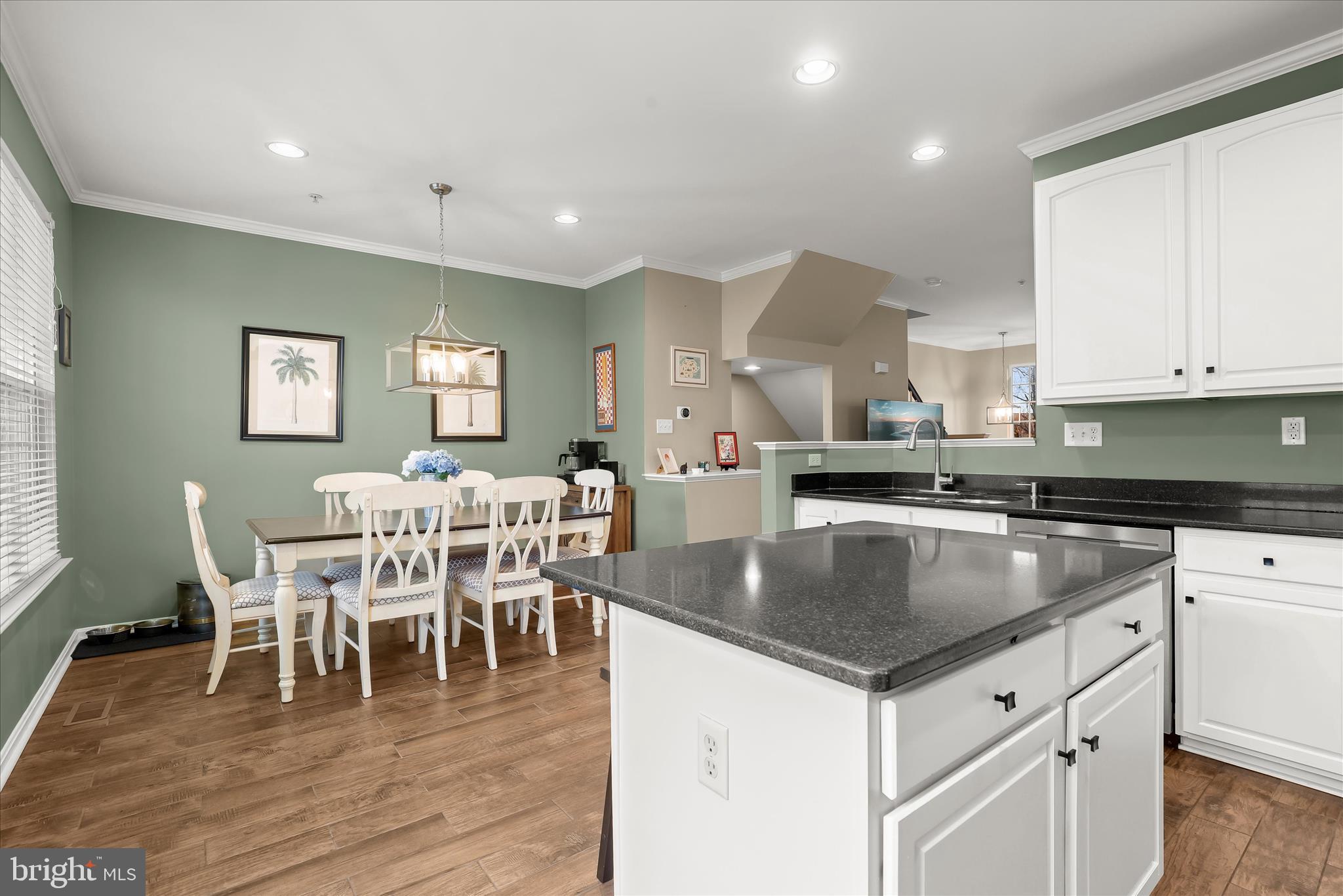 1055 Lily Way Odenton, MD 21113 - Photo 11 of 56 a kitchen with stainless steel appliances granite countertop a table chairs sink and cabinets