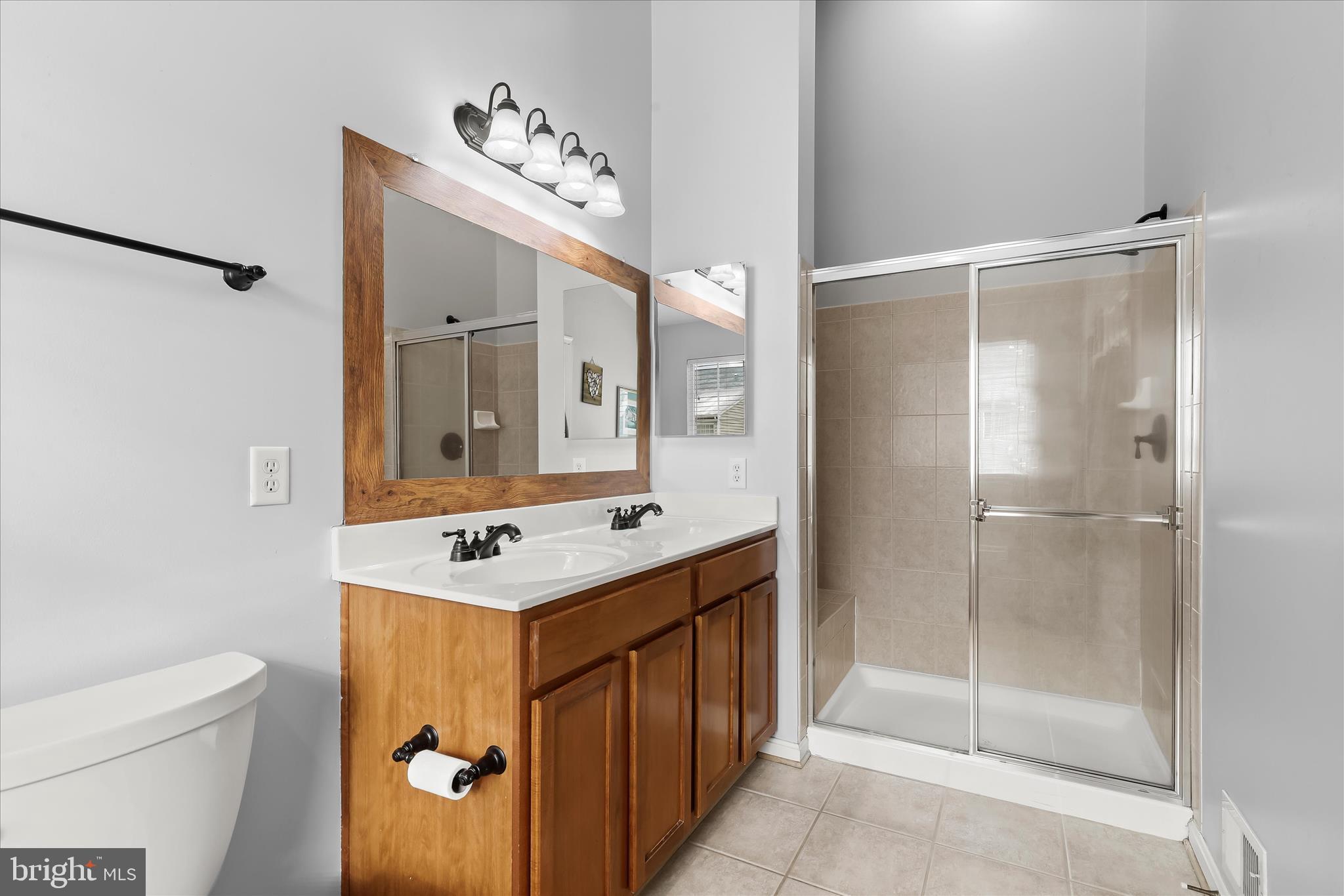 1055 Lily Way Odenton, MD 21113 - Photo 18 of 56 a bathroom with a sink toilet a mirror and shower