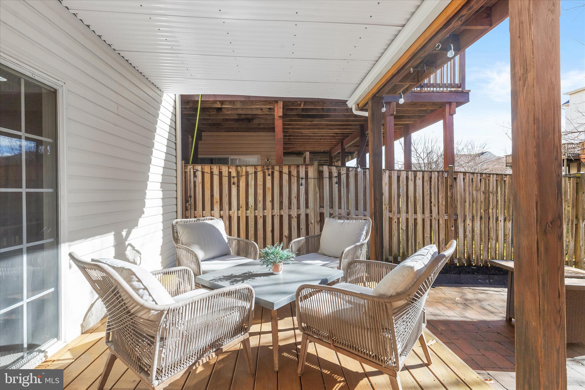 1055 Lily Way Odenton, MD 21113 - Photo 29 of 56 a view of a patio with a table and chairs