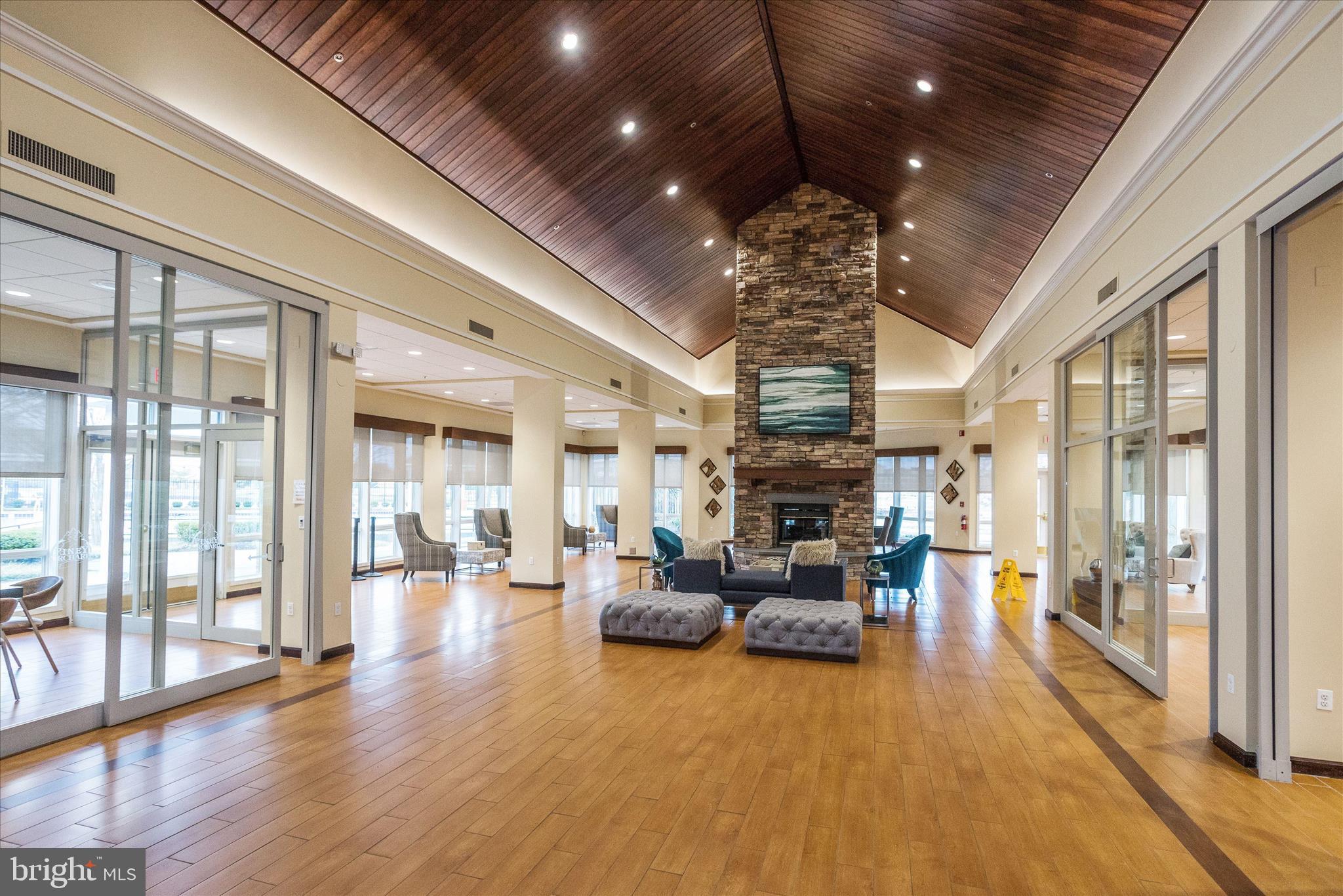 1055 Lily Way Odenton, MD 21113 - Photo 38 of 56 a view of a big room with wooden floor large windows a chandelier and pool table