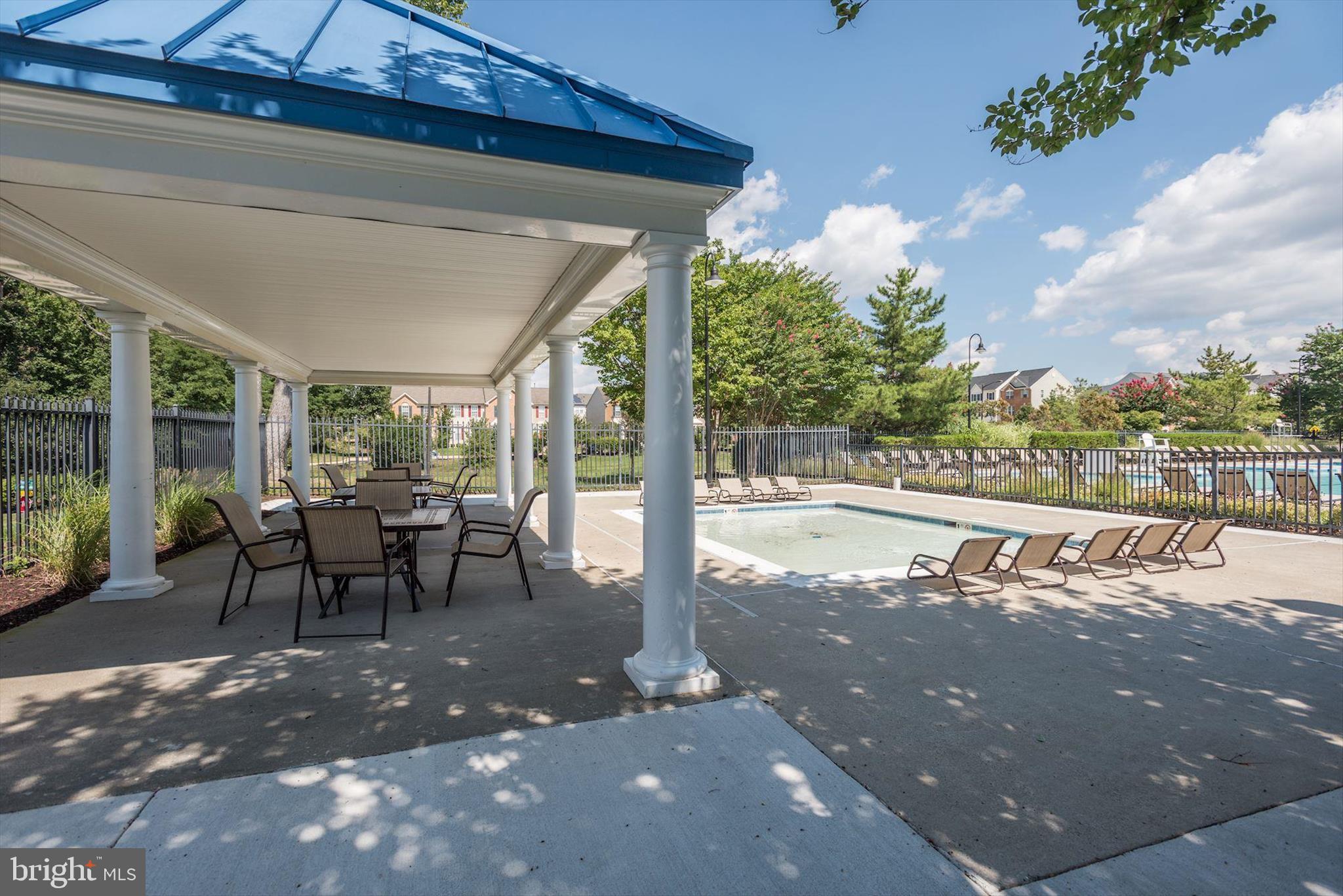 1055 Lily Way Odenton, MD 21113 - Photo 51 of 56 a view of a porch with chairs and backyard
