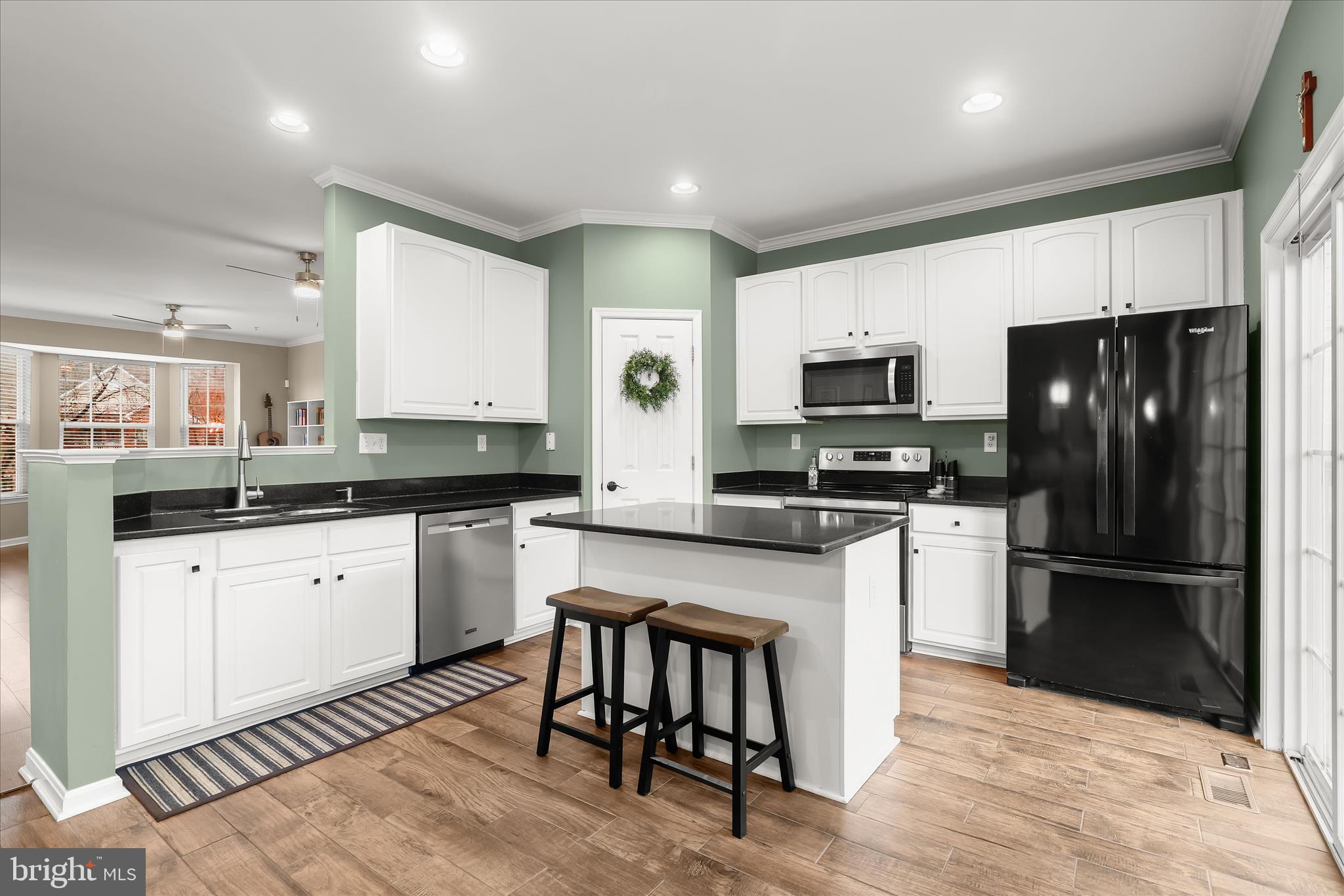 1055 Lily Way Odenton, MD 21113 - Photo 6 of 56 a kitchen with granite countertop a refrigerator stove microwave and cabinets