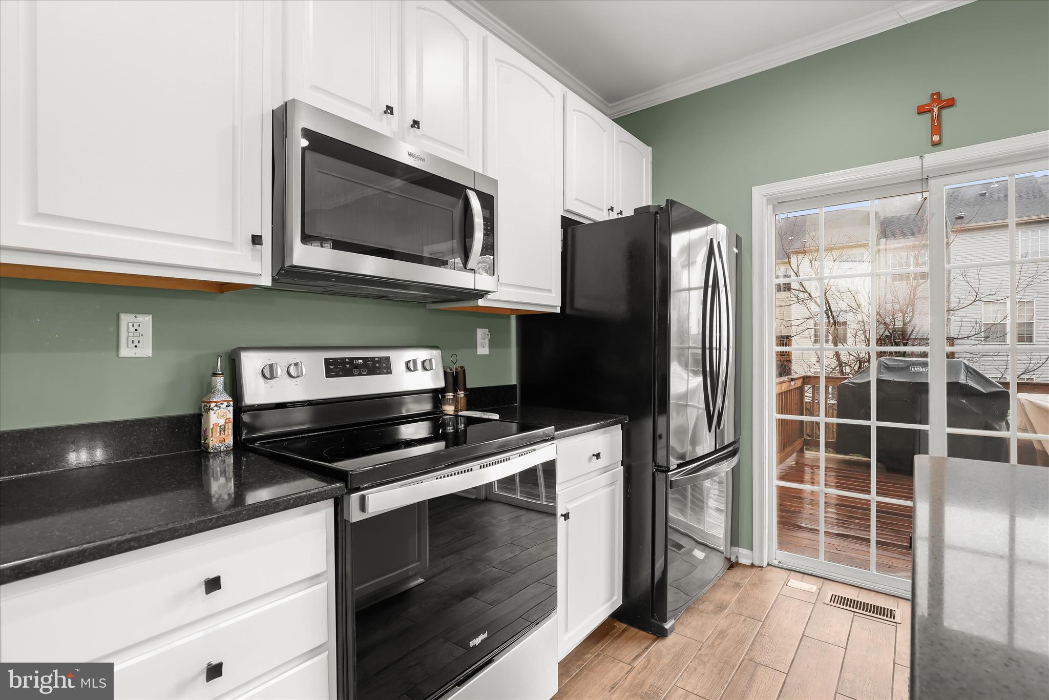 1055 Lily Way Odenton, MD 21113 - Photo 10 of 56 a kitchen with stainless steel appliances a stove a microwave and cabinets