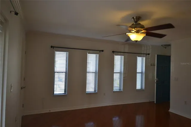 a view of wooden floor and windows in a room