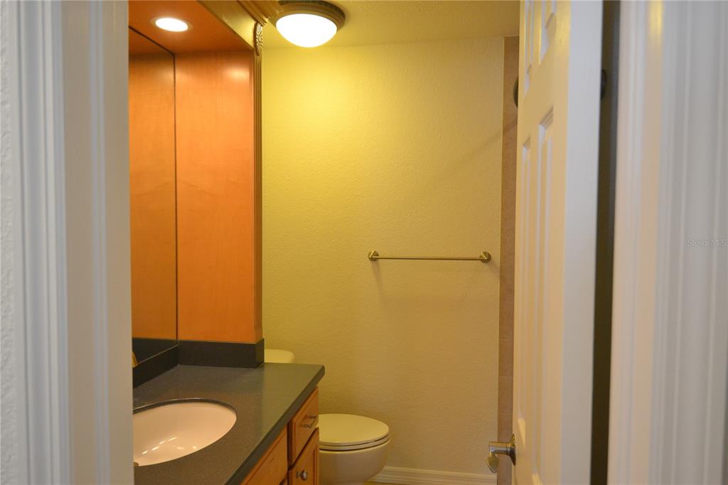 718 Lyndhurst Street, Unit 922 Dunedin, FL 34698 - Photo 22 of 39 a bathroom with a granite countertop sink and a toilet
