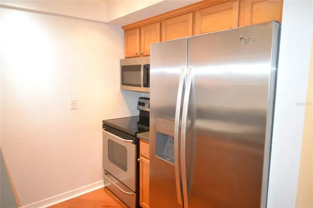 a kitchen with metallic refrigerator freezer and a dishwasher