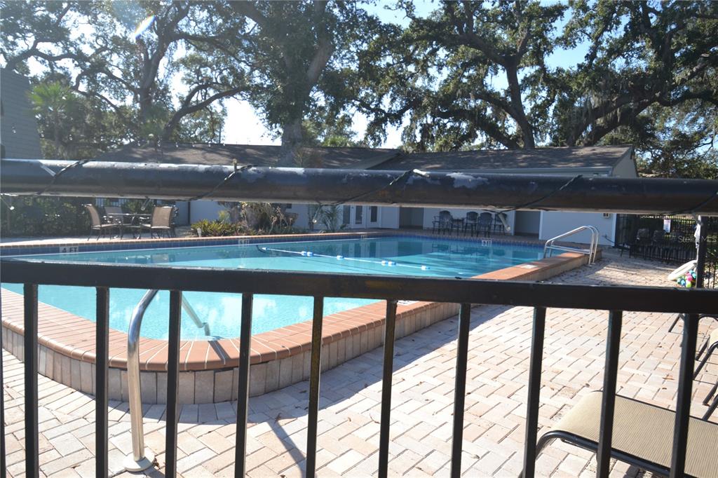 718 Lyndhurst Street, Unit 922 Dunedin, FL 34698 - Photo 32 of 39 a view of house with outdoor space and trees in the background