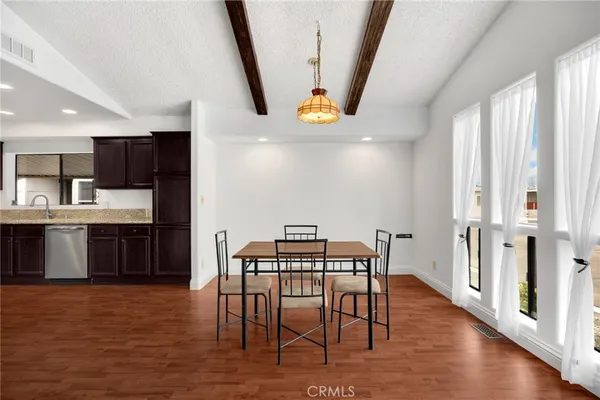 a view of a dining room with furniture window and wooden floor