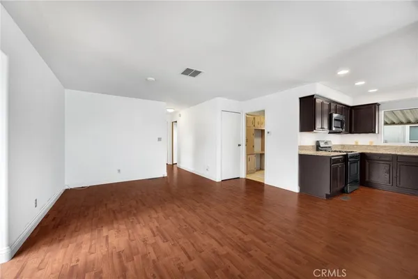 a view of kitchen with cabinets and wooden floor