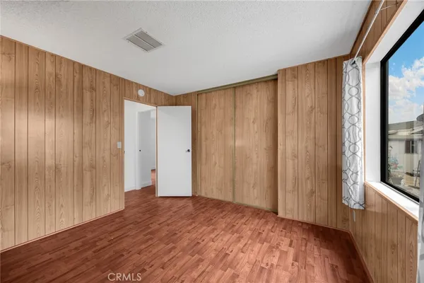 a view of a room with wooden floor and walls