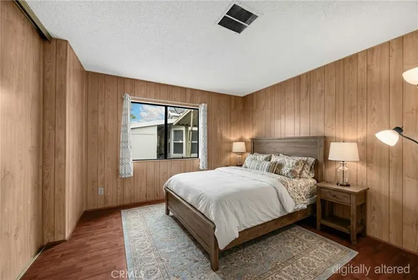 a bedroom with a bed and large window
