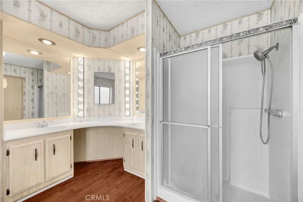 a bathroom with a shower sink and mirror