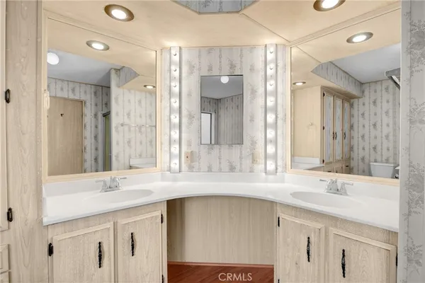 a bathroom with a sink double vanity and a mirror