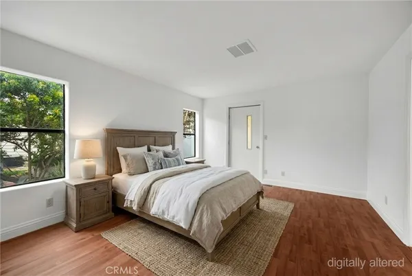 a bedroom with a bed and a large window