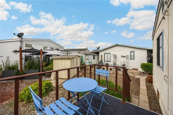 a view of a house with backyard and furniture