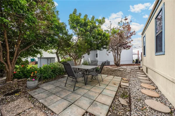a view of a patio with table and chairs and potted plants