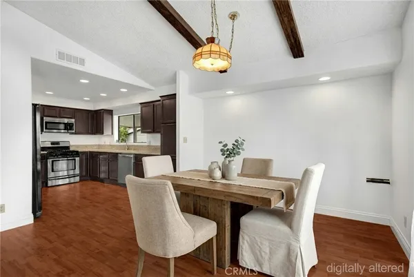 a dining room with furniture and chandelier