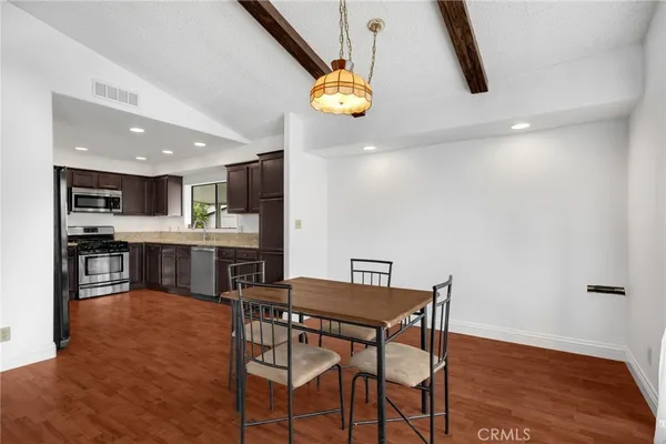 a dining room with furniture and chandelier