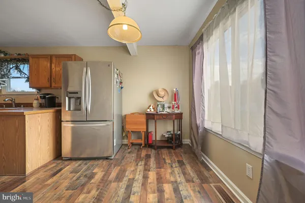 a view of kitchen and refrigerator