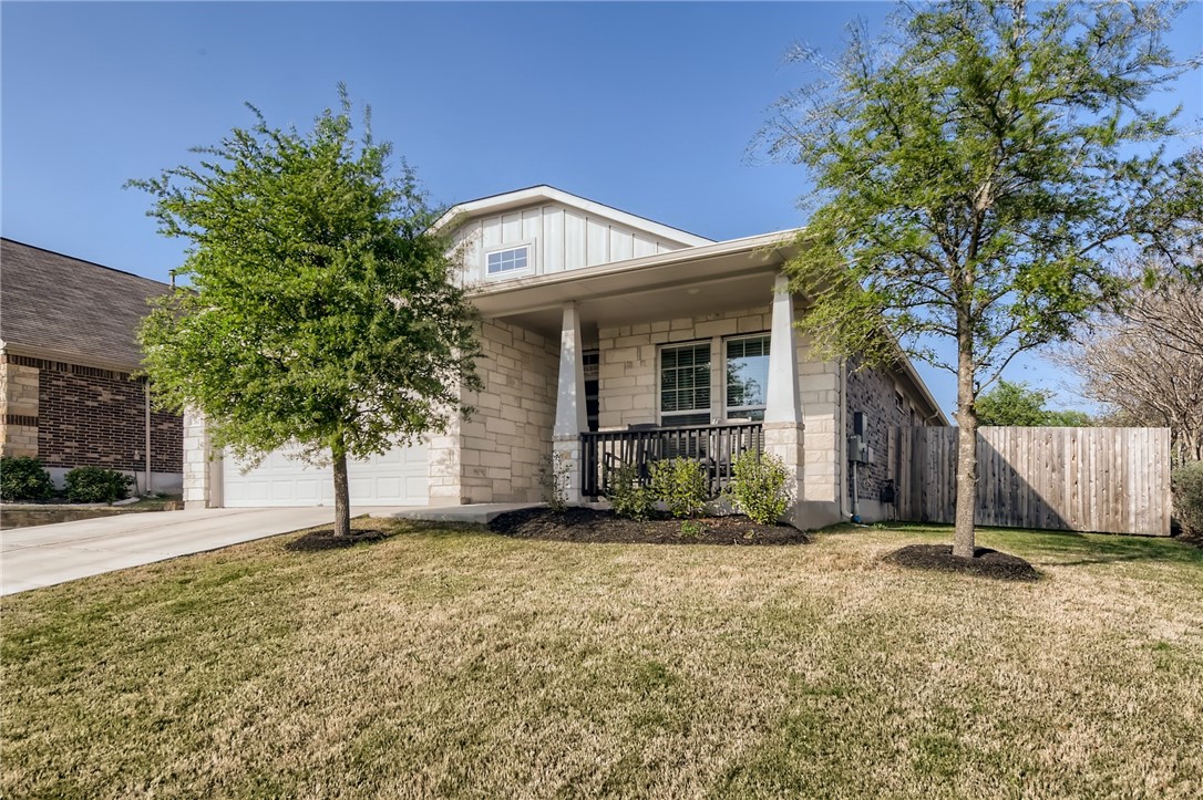 a view of a house with a tree in the background