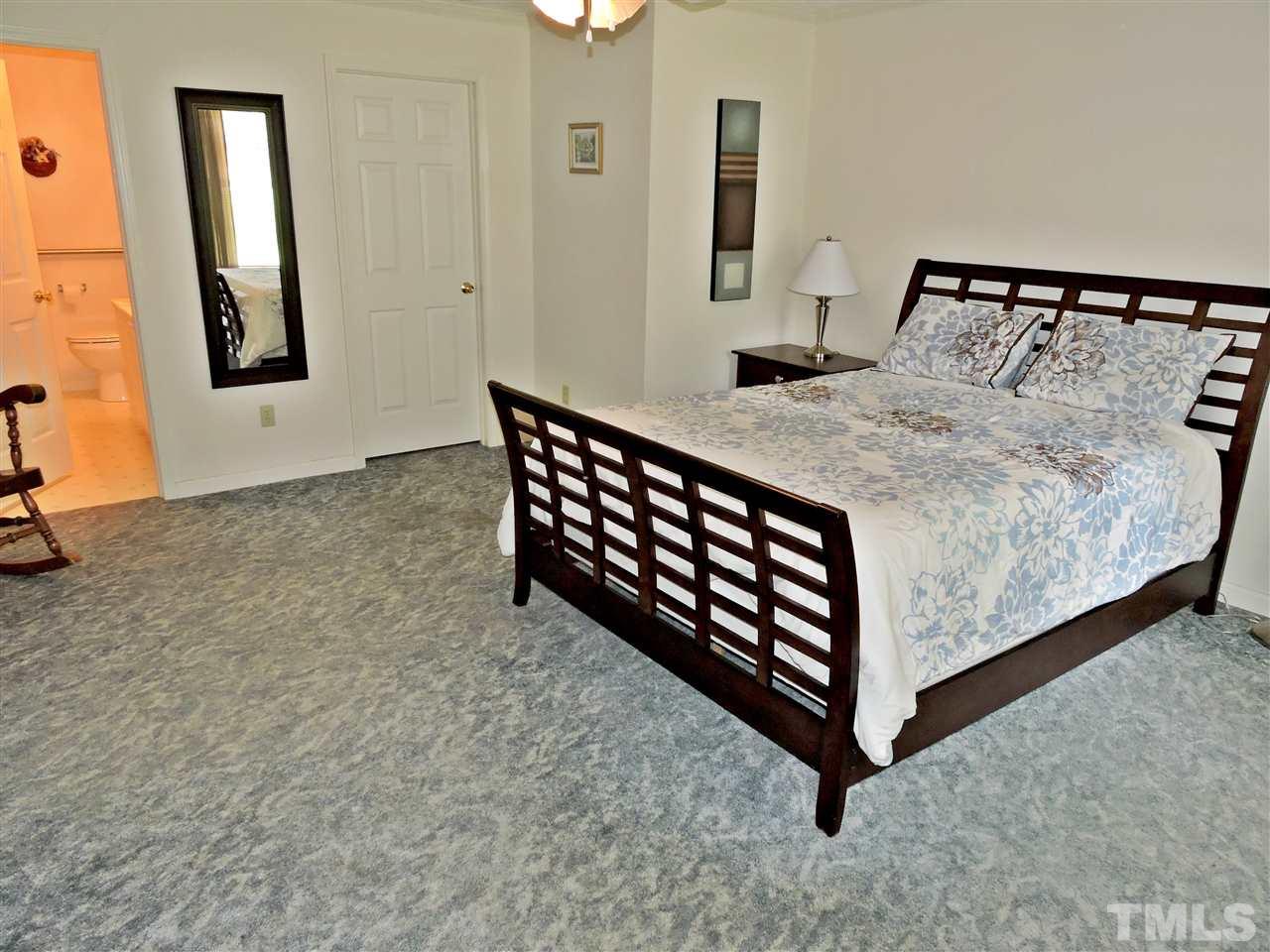 21 Landmark North Roxboro, NC 27574 - Photo 11 of 25 a bed sitting in a bedroom next to a window