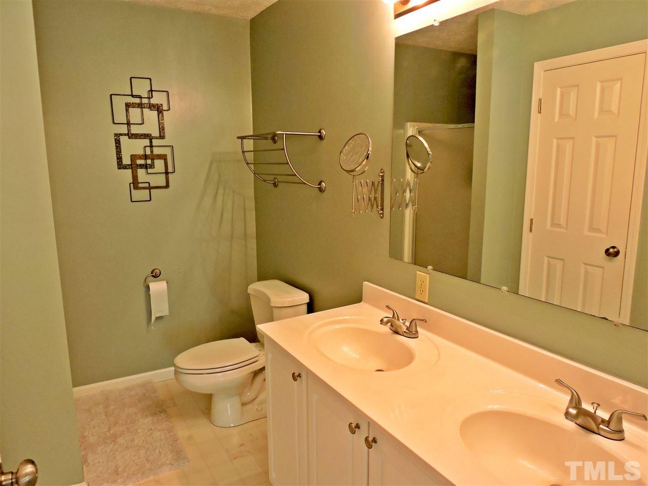 21 Landmark North Roxboro, NC 27574 - Photo 14 of 25 a bathroom with a sink and mirror with toilet