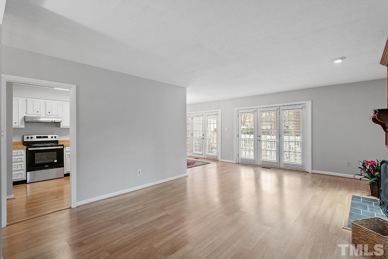 700 Green Ridge Drive Raleigh, NC 27609 - Photo 11 of 33 a view of an empty room with wooden floor and a window