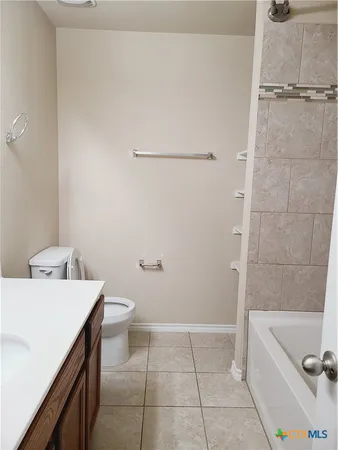a bathroom with a sink a toilet and tub