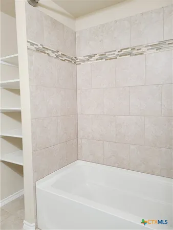 a bathroom with a shower and a bathtub
