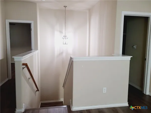 a view of a hallway with furniture