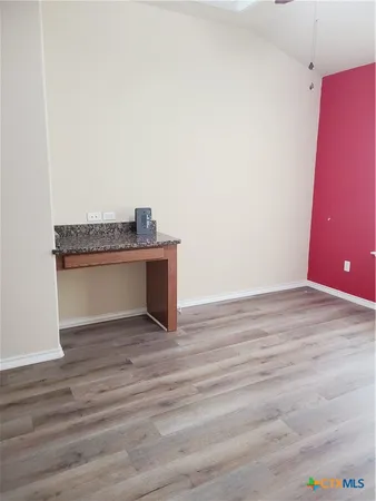 a view of a room with a sink and a mirror
