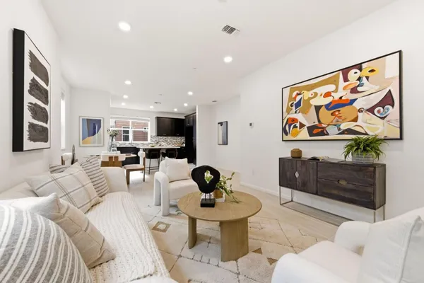 a living room with furniture and wall paintings