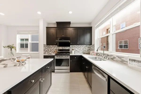 a kitchen with a sink stove top oven and refrigerator