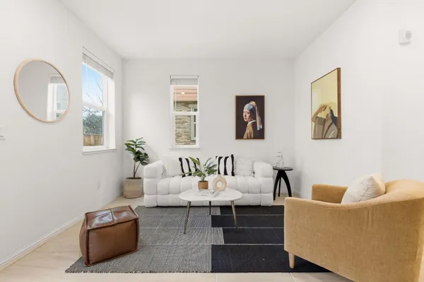 a living room with furniture and a mirror