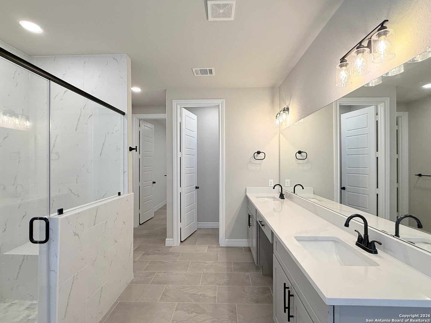 1313 Fm 3175 Lytle, TX 78052 - Photo 15 of 45 a bathroom with a double vanity sink mirror and shower