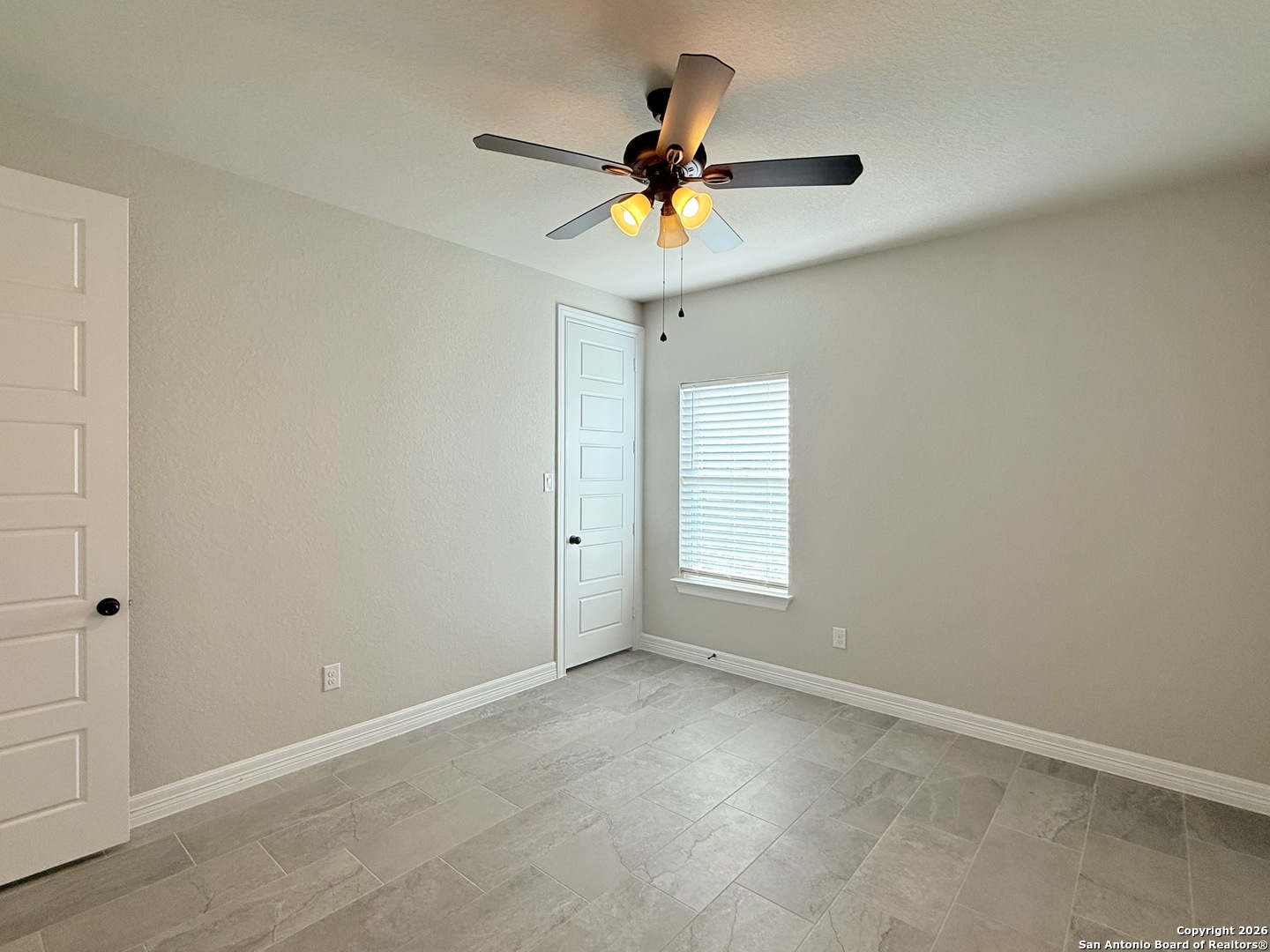 1313 Fm 3175 Lytle, TX 78052 - Photo 23 of 45 an empty room with a ceiling fan and window