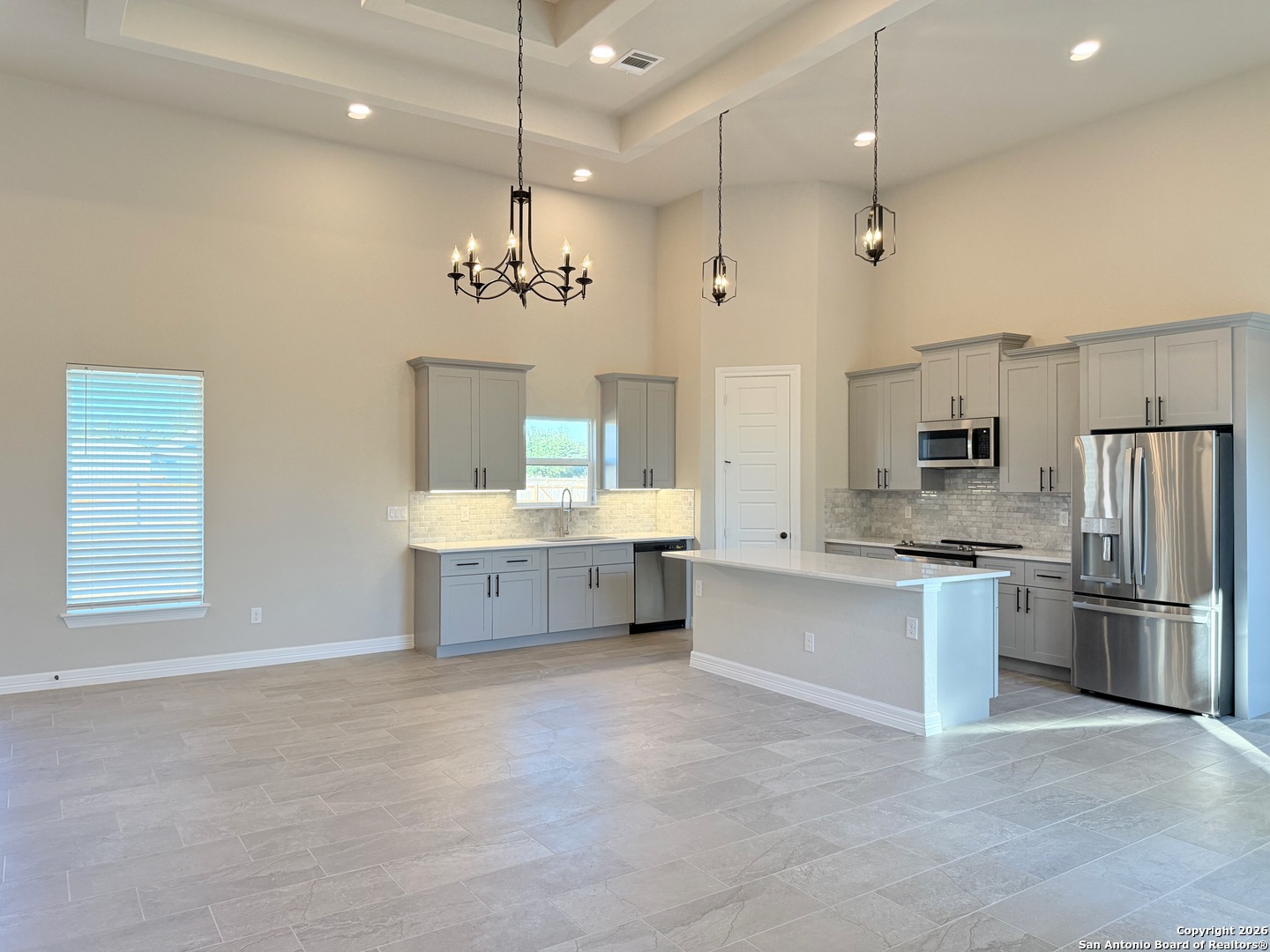 1313 Fm 3175 Lytle, TX 78052 - Photo 9 of 45 a large kitchen with stainless steel appliances a large counter top a sink a stove and refrigerator