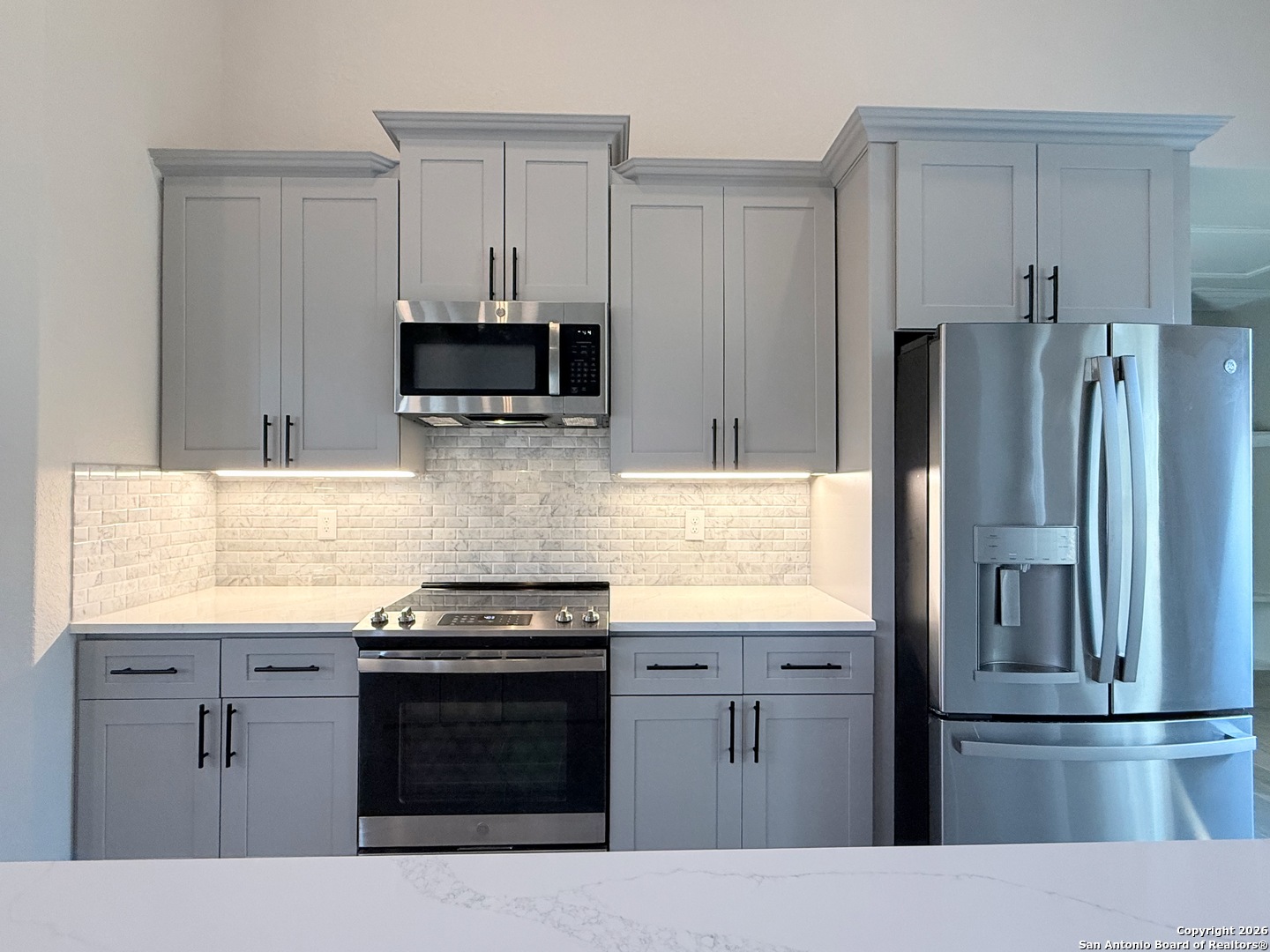 1313 Fm 3175 Lytle, TX 78052 - Photo 10 of 45 a kitchen with stainless steel appliances kitchen island granite countertop a stove and a refrigerator