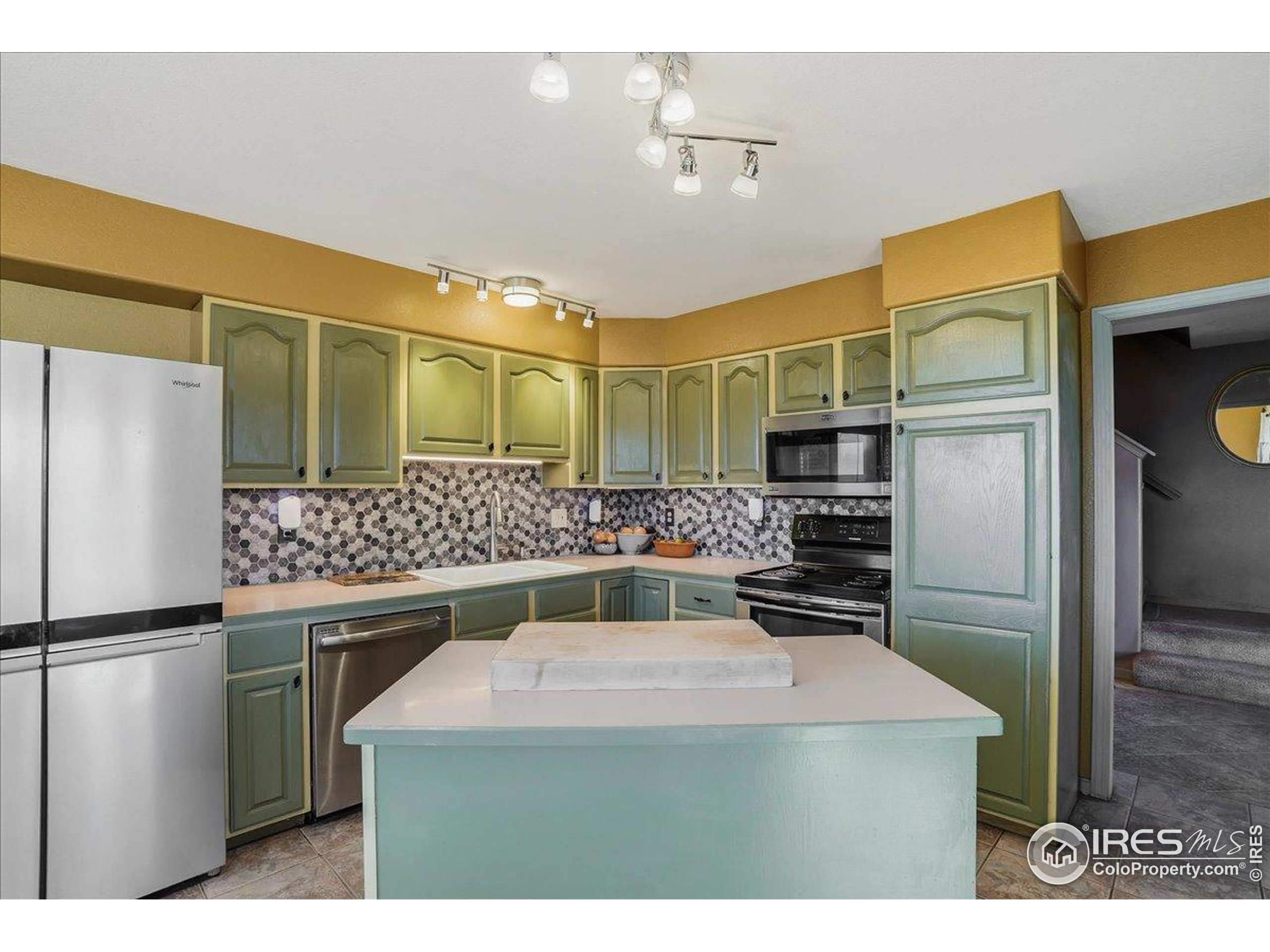 601 Red Mountain Road Livermore, CO 80536 - Photo 11 of 49 a kitchen with stainless steel appliances a refrigerator and a stove