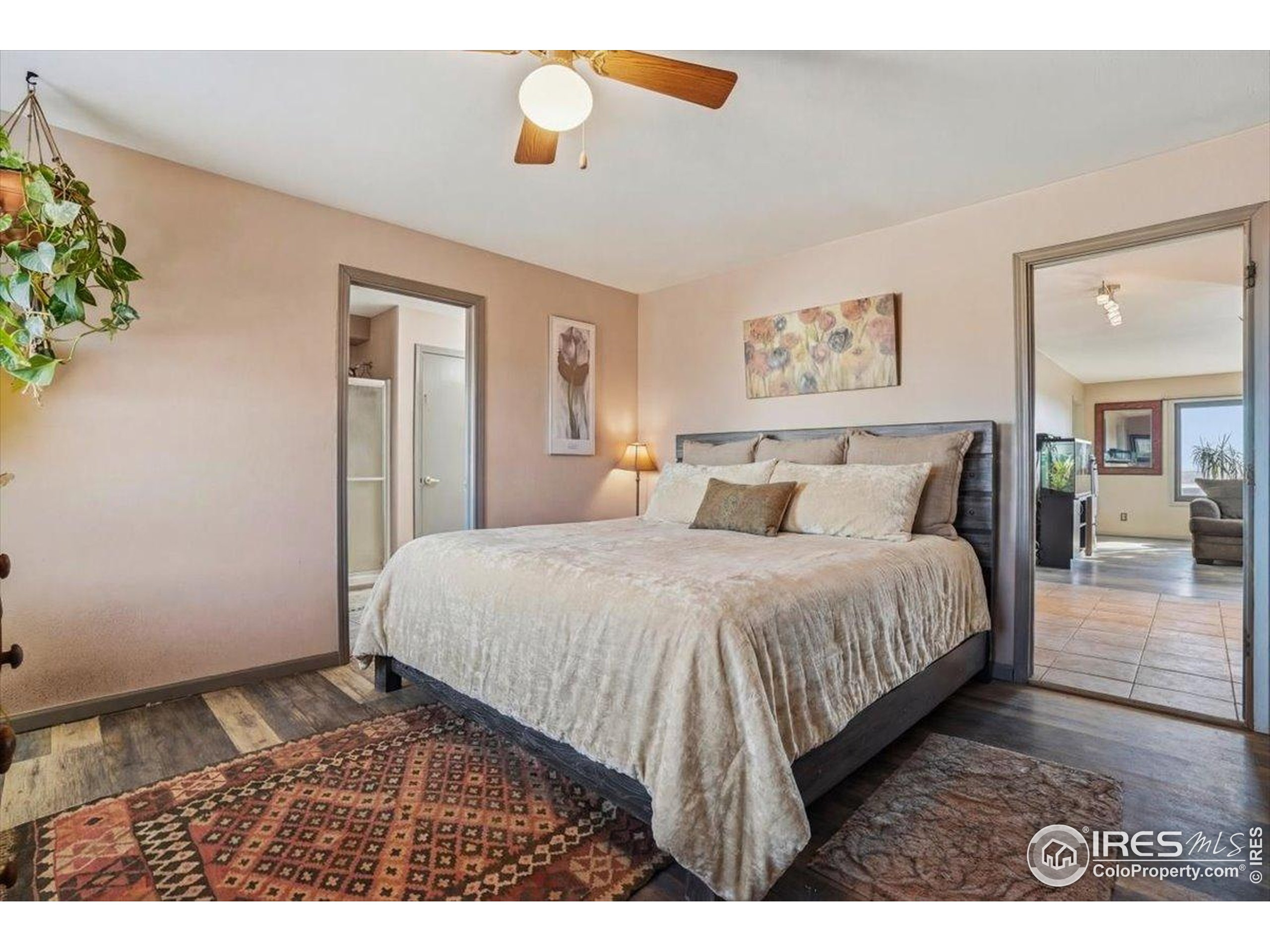 601 Red Mountain Road Livermore, CO 80536 - Photo 14 of 49 a bedroom with a bed and a painting on the wall