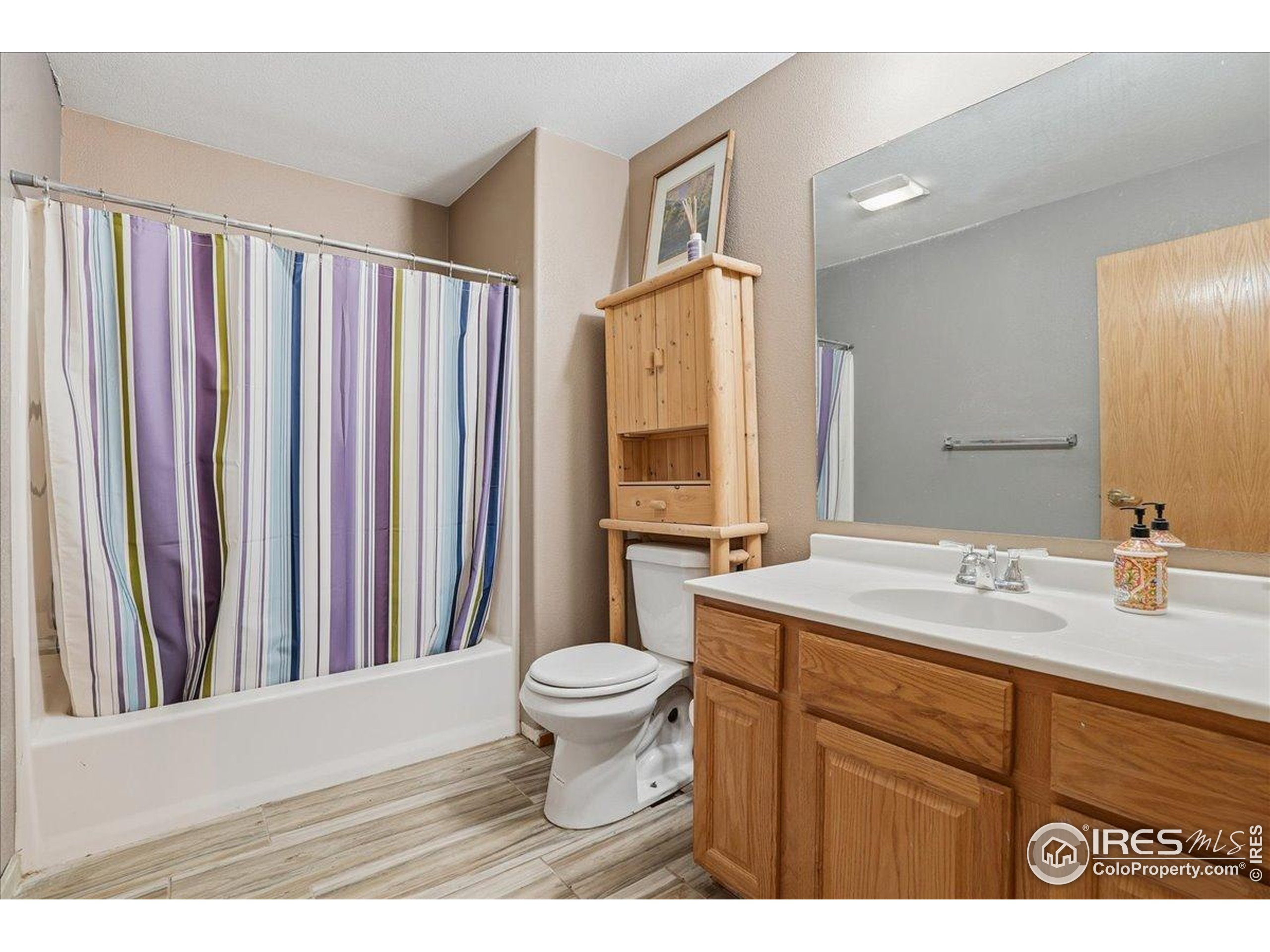 601 Red Mountain Road Livermore, CO 80536 - Photo 22 of 49 a bathroom with a sink a toilet a mirror and shower curtain