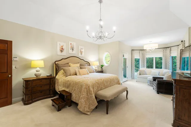 a spacious bedroom with a bed and large windows