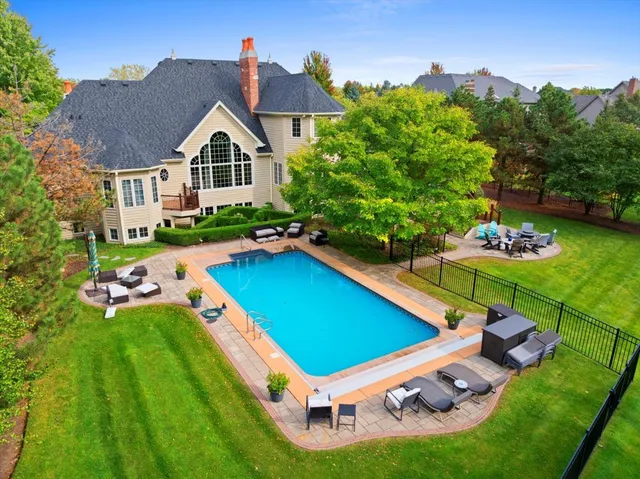 a aerial view of a house with swimming pool and garden